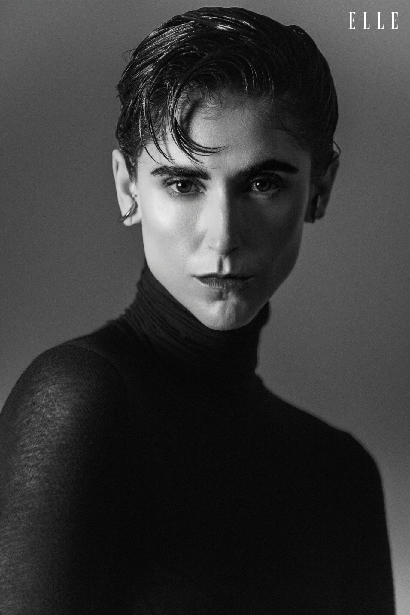 Close-up portrait of Daiane Conterato in a dark high-neck blouse.