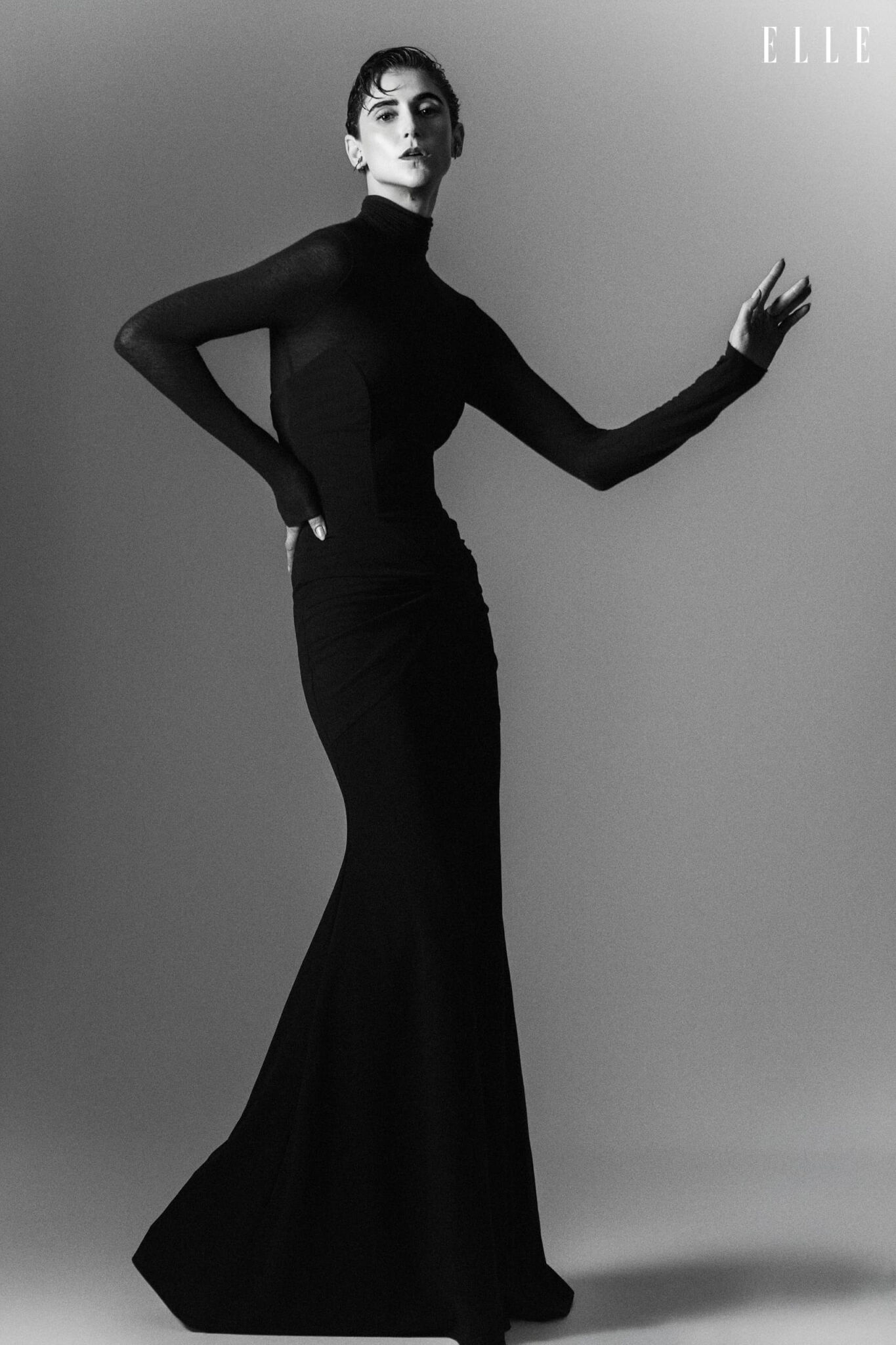 Daiane Conterato in a floor-length dark dress and high-neck blouse.