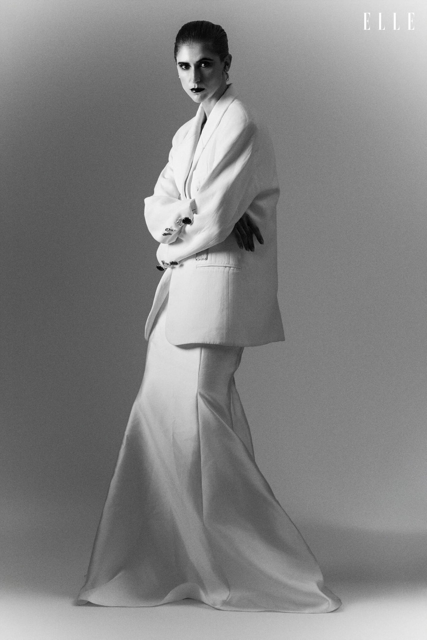 Full-length portrait of Daiane Conterato in a light blazer and flowing dress.