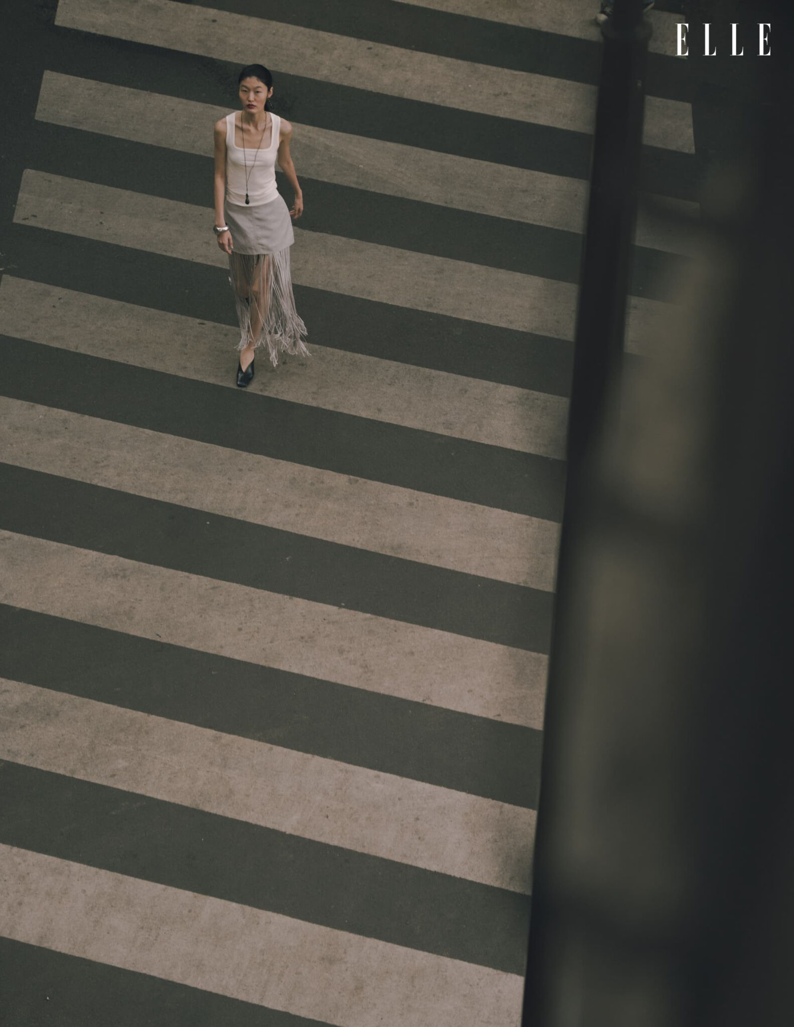 Overhead view of Qian Wen Wu on a striped pedestrian crossing