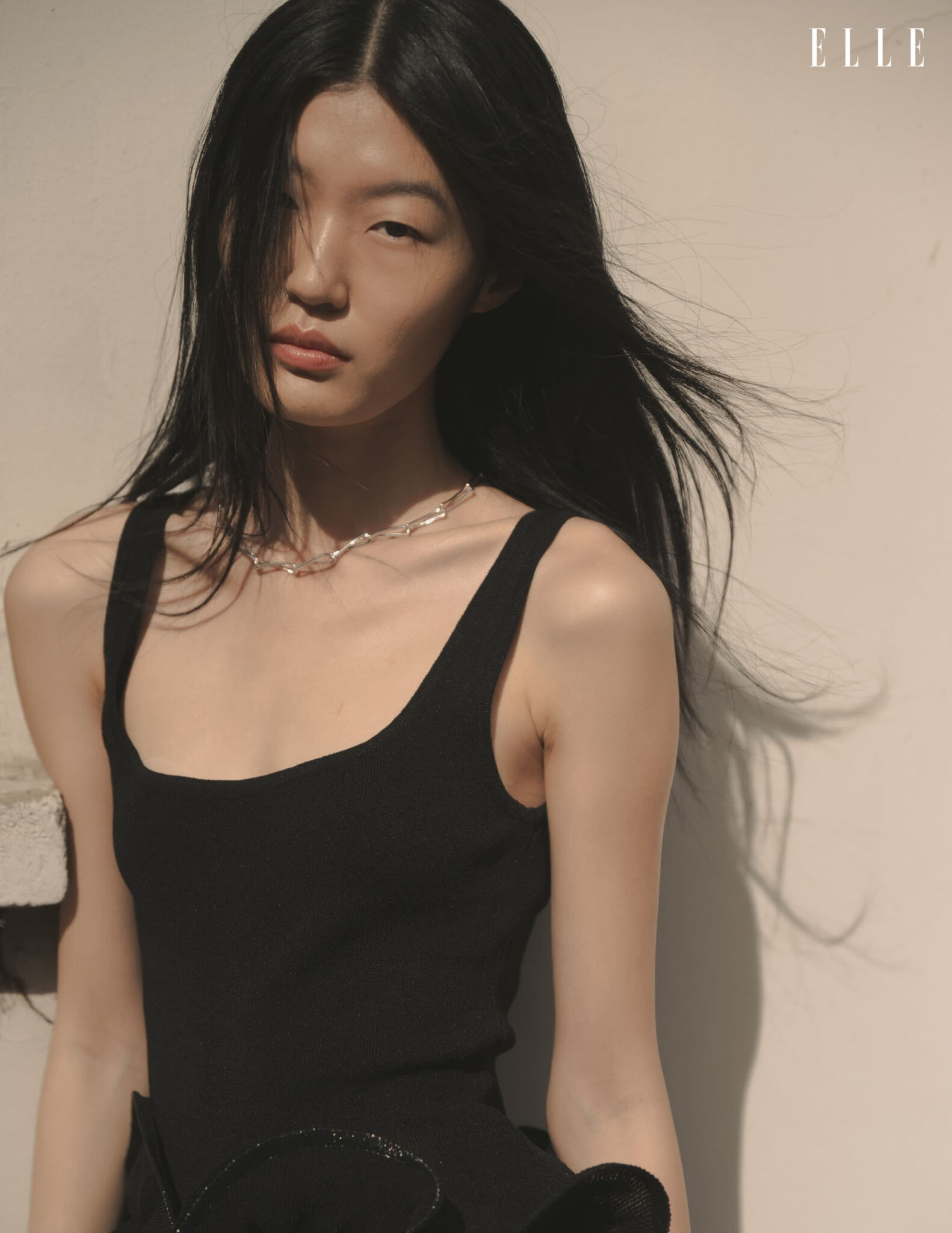 Portrait of Qian Wen Wu in a black top and gold-tone necklace