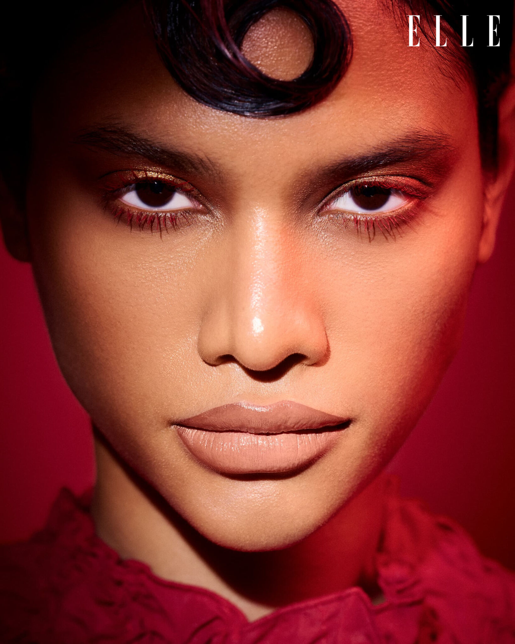 Beauty portrait with sculpted hair and warm red eye makeup