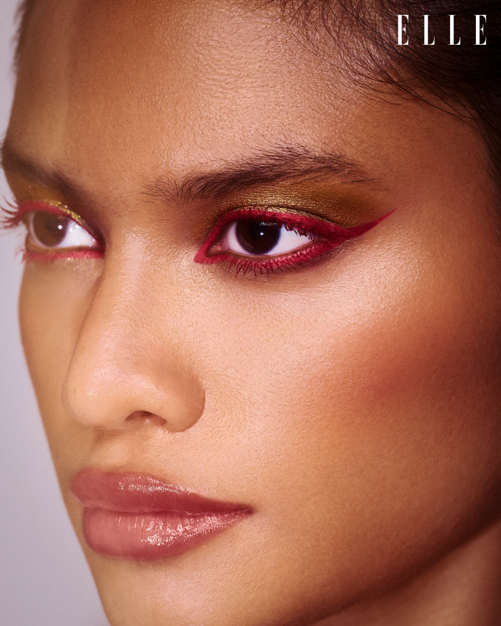 Beauty portrait with red eyeliner and gold eyeshadow