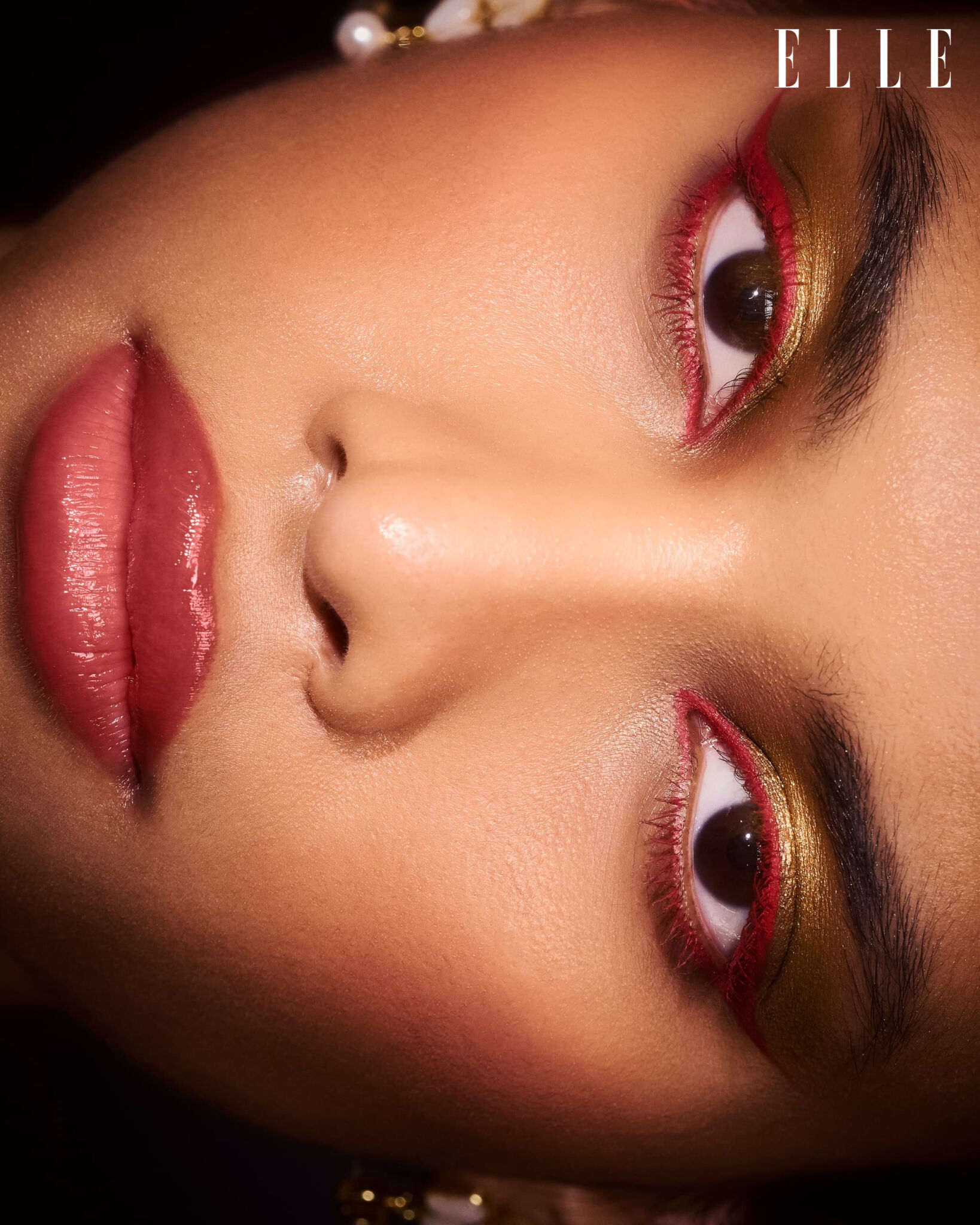 Reclining beauty portrait with red and gold eye makeup