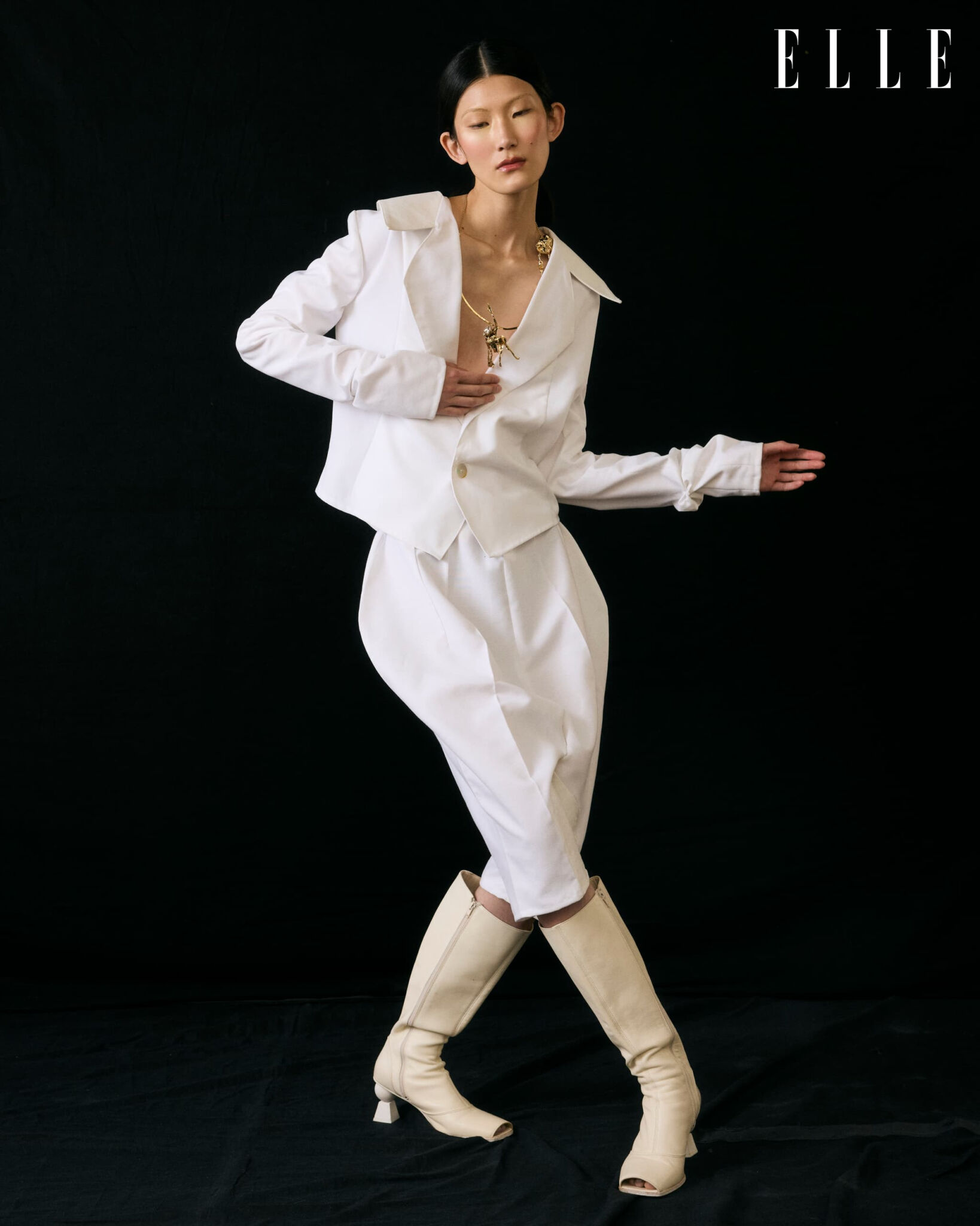 Cheng Peng in motion in a white Atede outfit and Jacquemus boots.