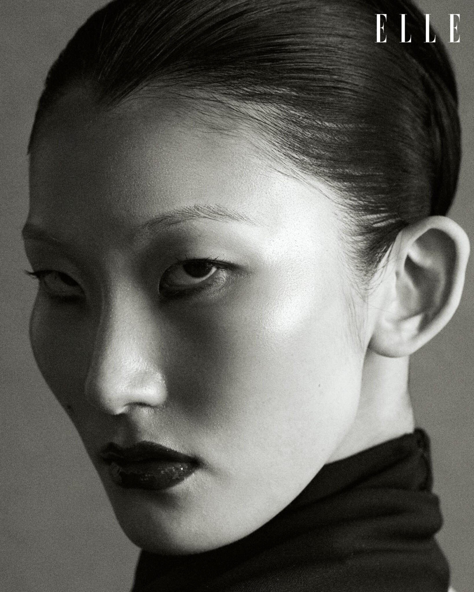 Black-and-white close-up of Cheng Peng wearing a black Alaïa jumpsuit.