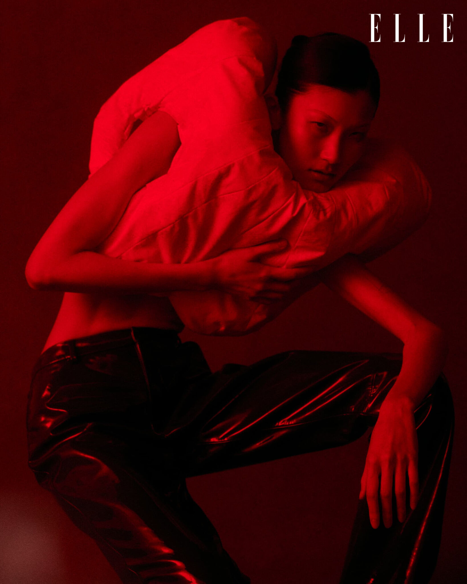 Cheng Peng in a Denholm Bruce top and trousers under red light.